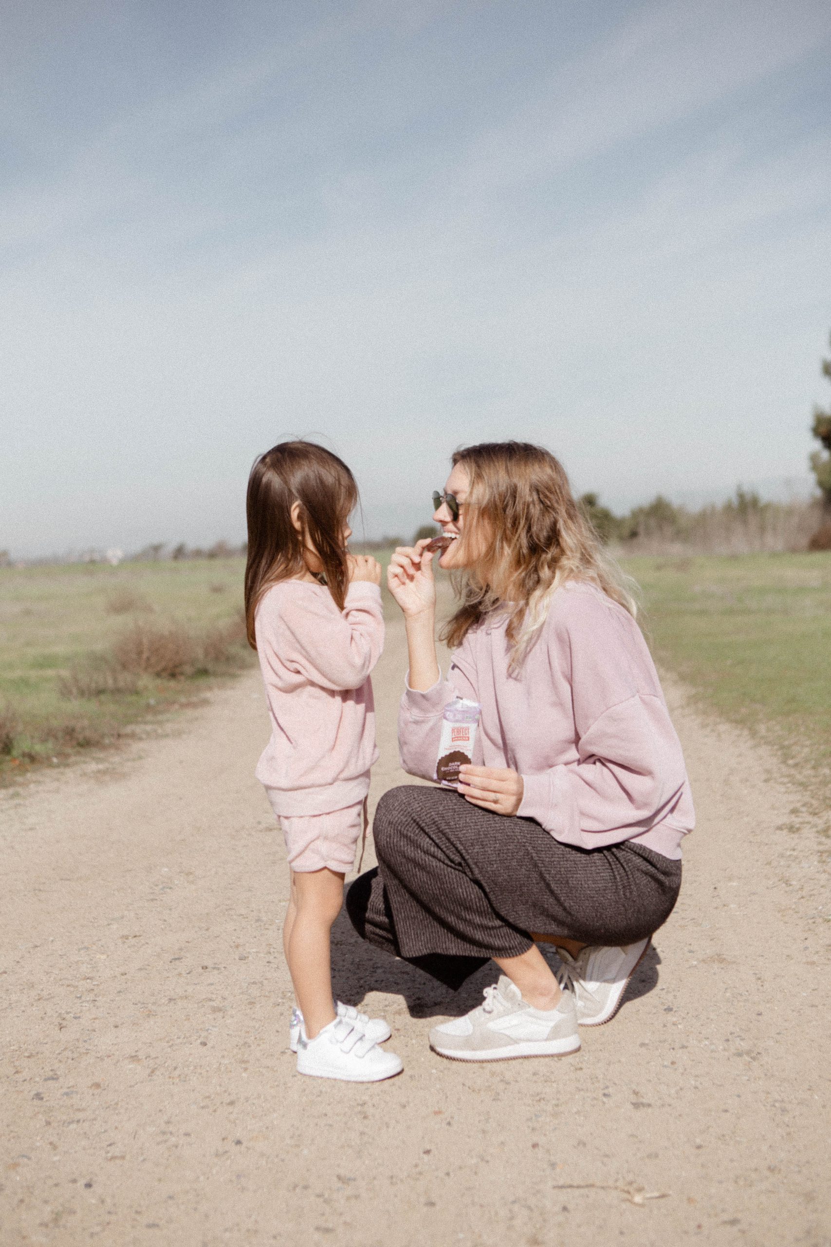 Mother teaching daughter at home, highlighting the benefits of home-based education in Auckland.