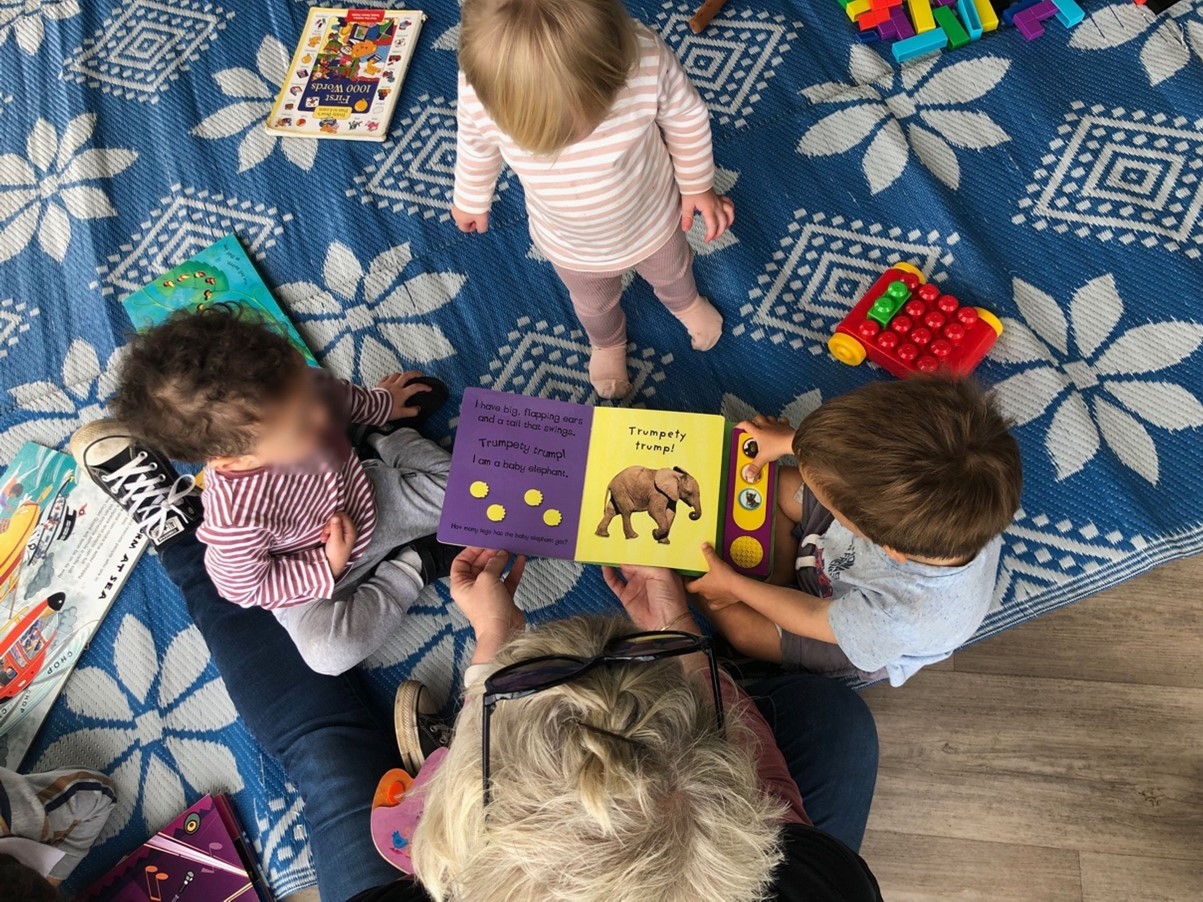 Home-based educator interacting with a child in a nurturing home based early childhood education setting