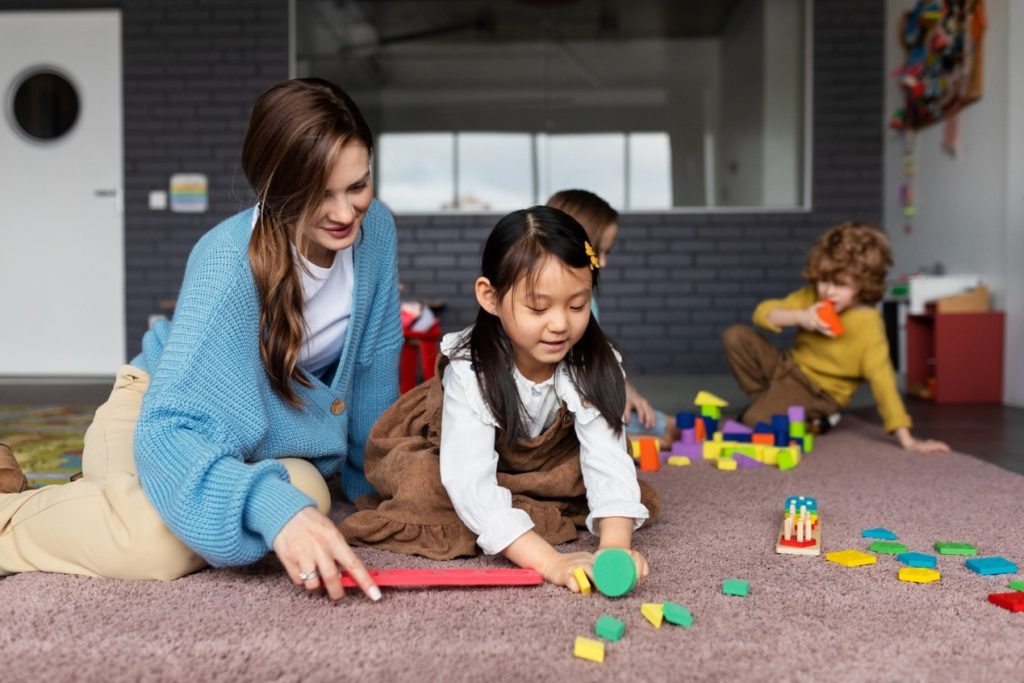 A diverse group of young children engaged in creative play at an early childhood education center in New Zealand, reflecting inclusivity and holistic learning.