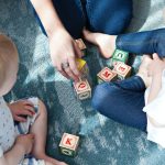 Children engaging in learning activities at a home-based childcare setting with KiaOraKids, promoting socialization and development