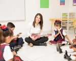 Happy home-based early childhood educator working with young children in New Zealand